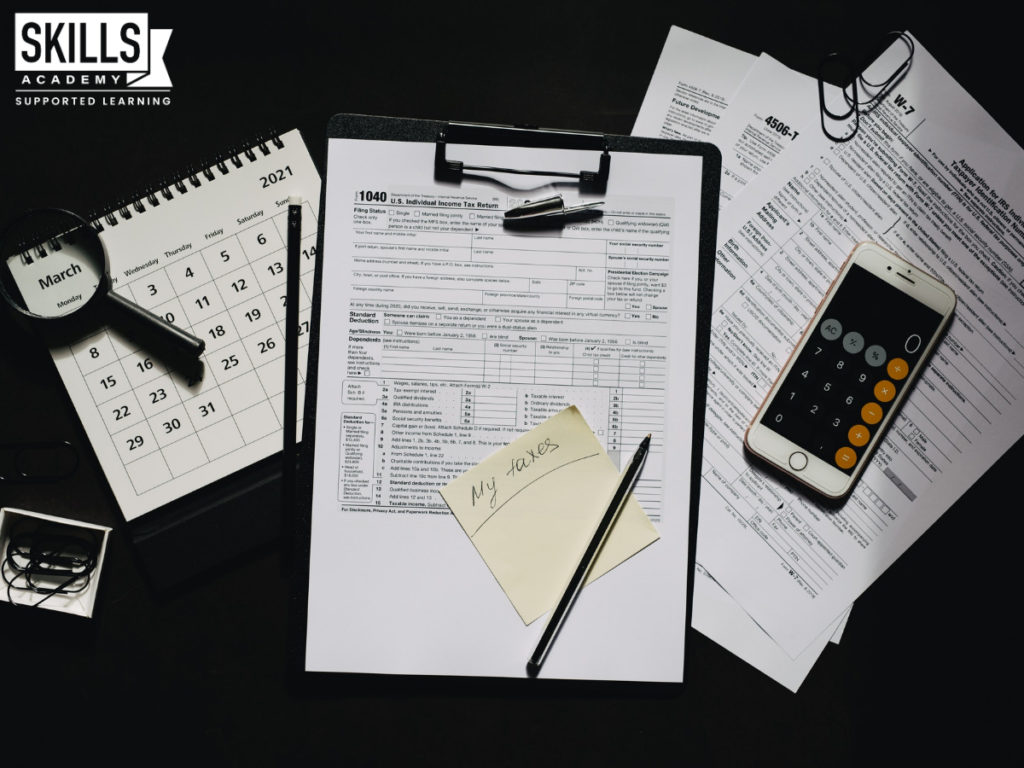 Tax forms, calculator and calendar on a table. Learn the finance skills you need with our Bookkeeping Courses.