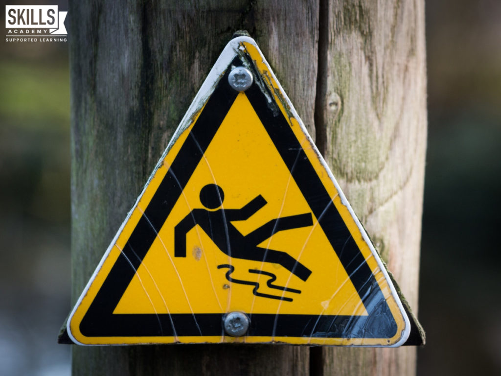 Slippery when wet yellow caution sign. Learn all about health and safety in our Occupational Health and Safety Courses.