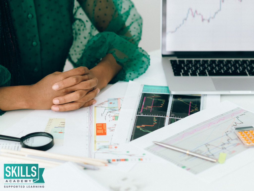 Woman looking through documents analysing the financial risks in the company. Gain top skills in our Risk Management Courses.