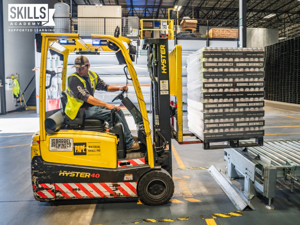 Forklift driver loading goods in a warehouse. Gain top skills in our Supply Chain Courses.