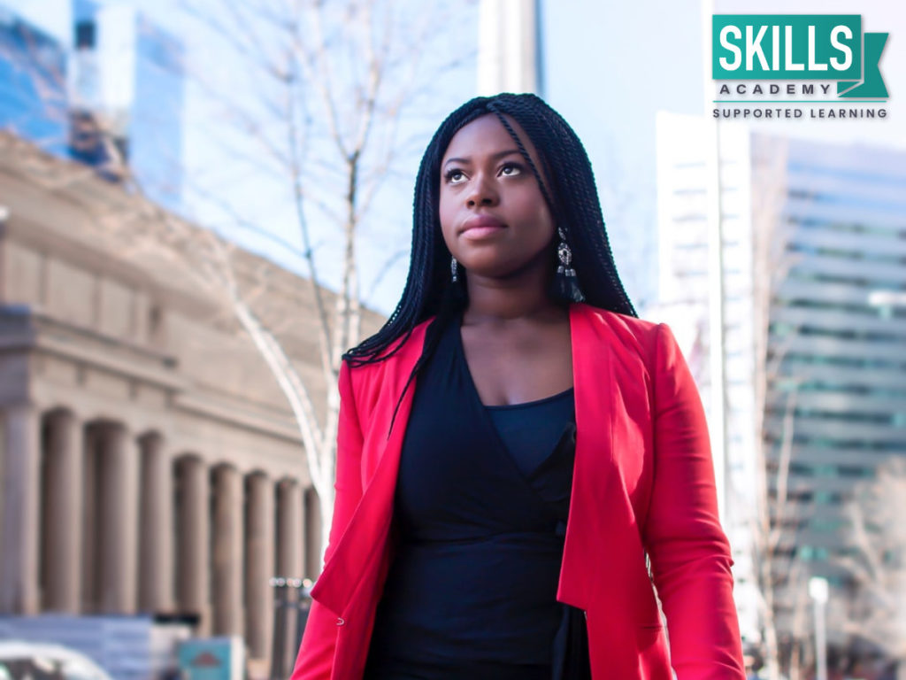 A young woman dressed professionally in a red blazer. Your professionalism can also be worked on with these call centre management courses.