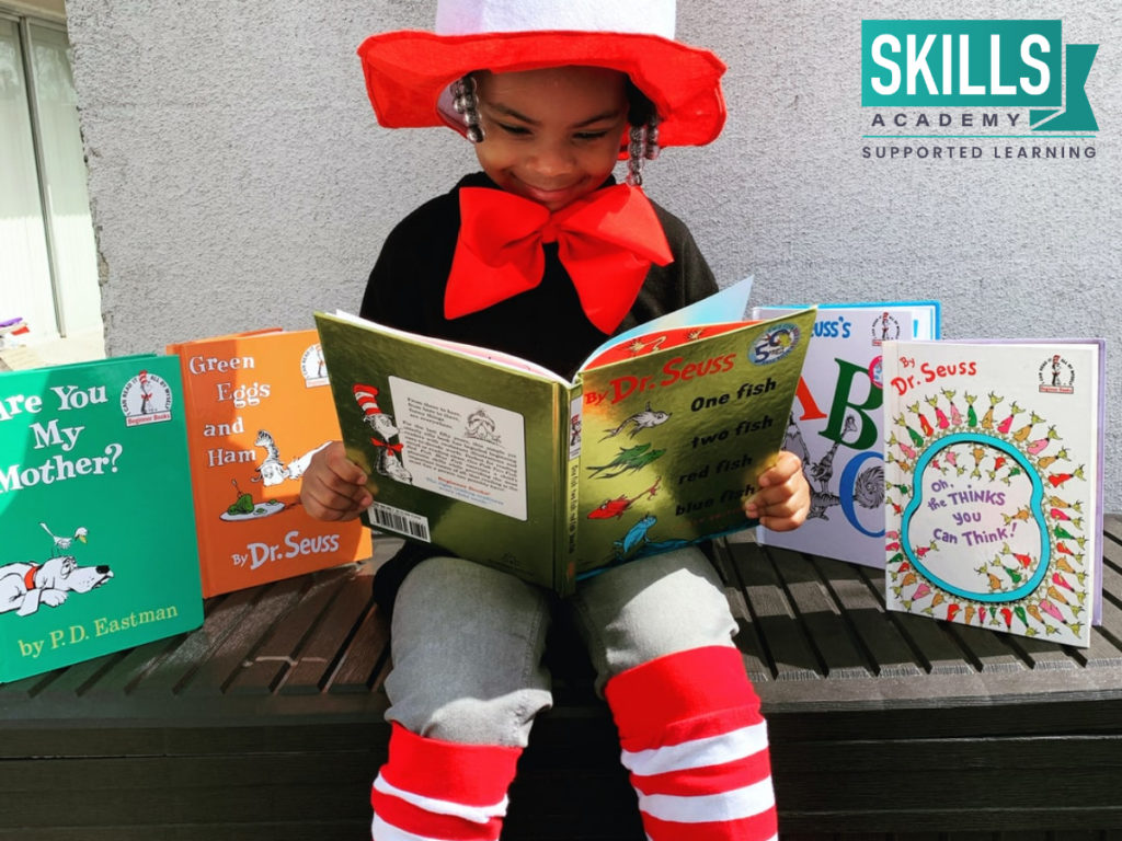 Child reading books while dressed up. Teach children their ABC's with our Educare and Child Care Courses.