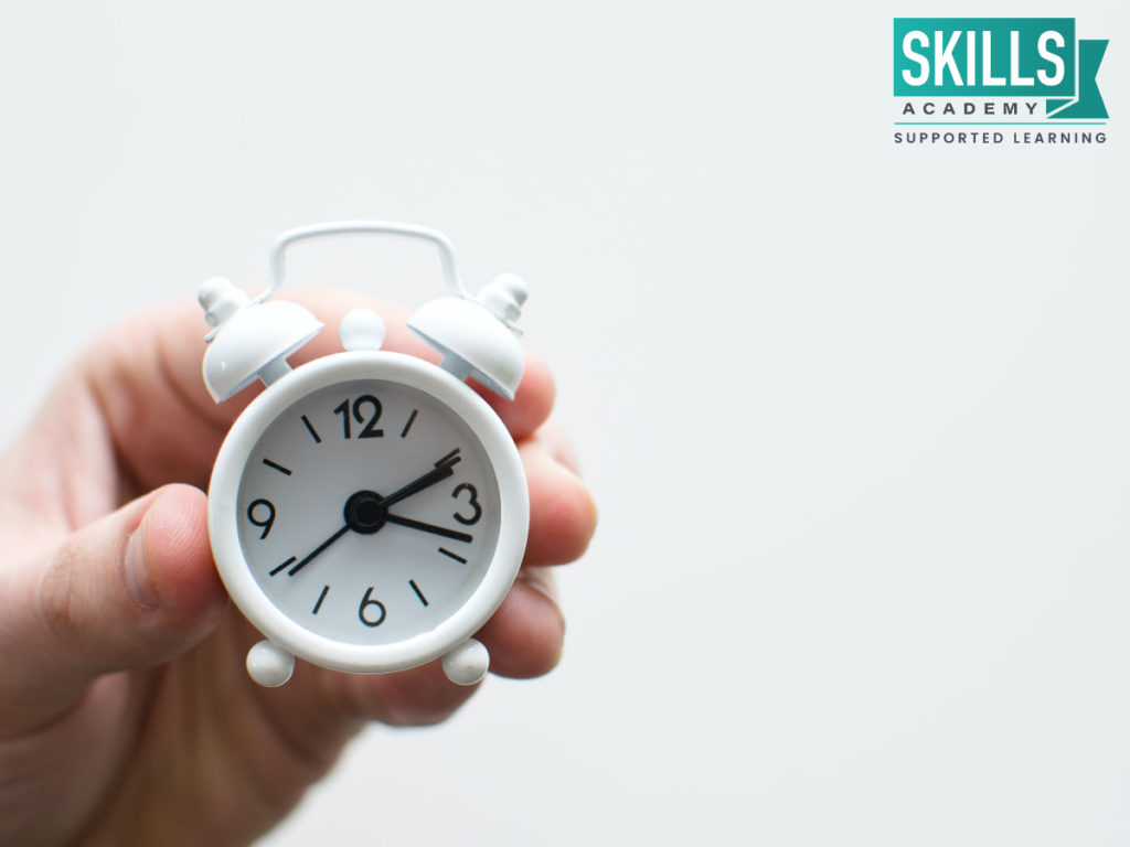 Hand holding a clock. Wondering What are Short Courses? Find out how our short courses can help you succeed in your career.
