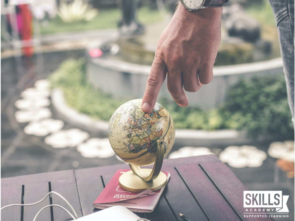Person using their index finger to touch a world globe and find a job using their internationally recognised courses qualification. Study our Internationally Recognised Courses