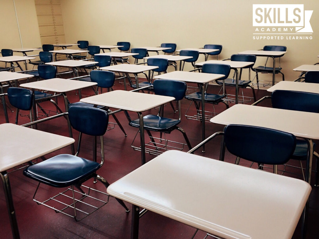 Tables and chairs in a classroom. Rewriting Matric will help you get the marks you deserve.