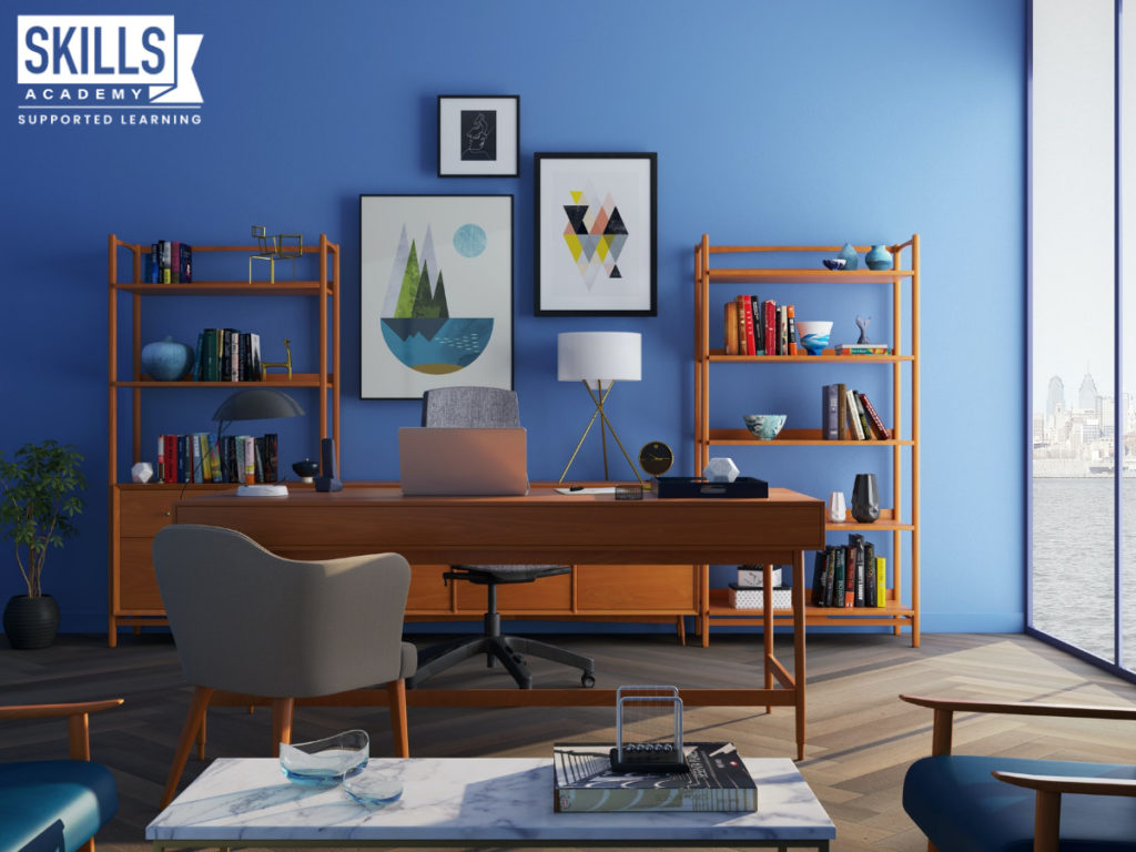 A home office with a painted blue wall and furniture. Learn the Essential Skills for an Interior Decorator to create this right here.