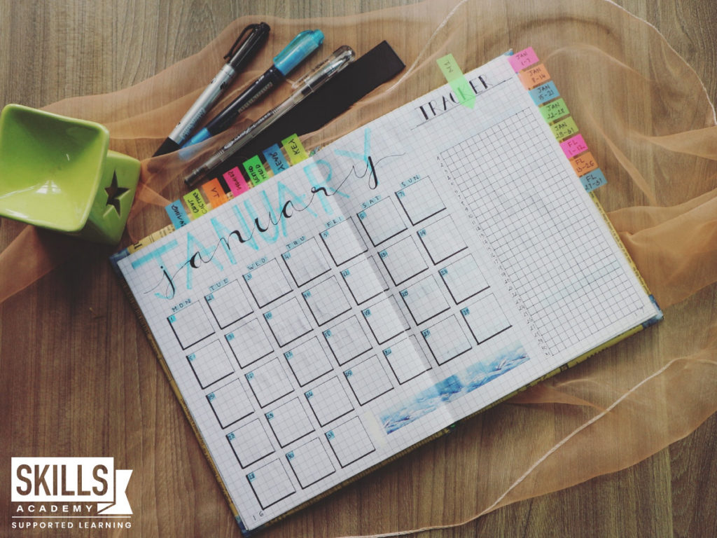 A monthly planner and colourful pens on a table. These tools can help you learn How to Maintain Your Study Goals