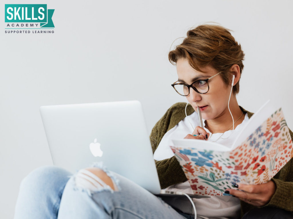 A female student using a laptop to figure out how to get the Most out of an HR Course