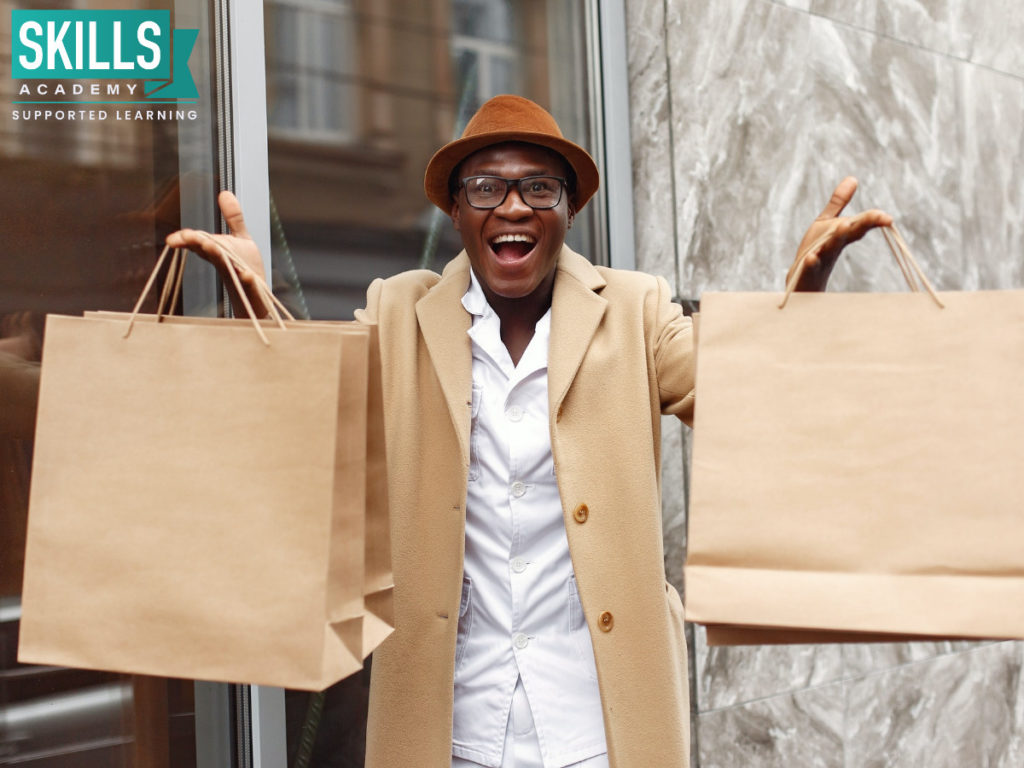 Excited young man with shopping bags after learning about Side Hustles That Will Earn you Money this Festive Season