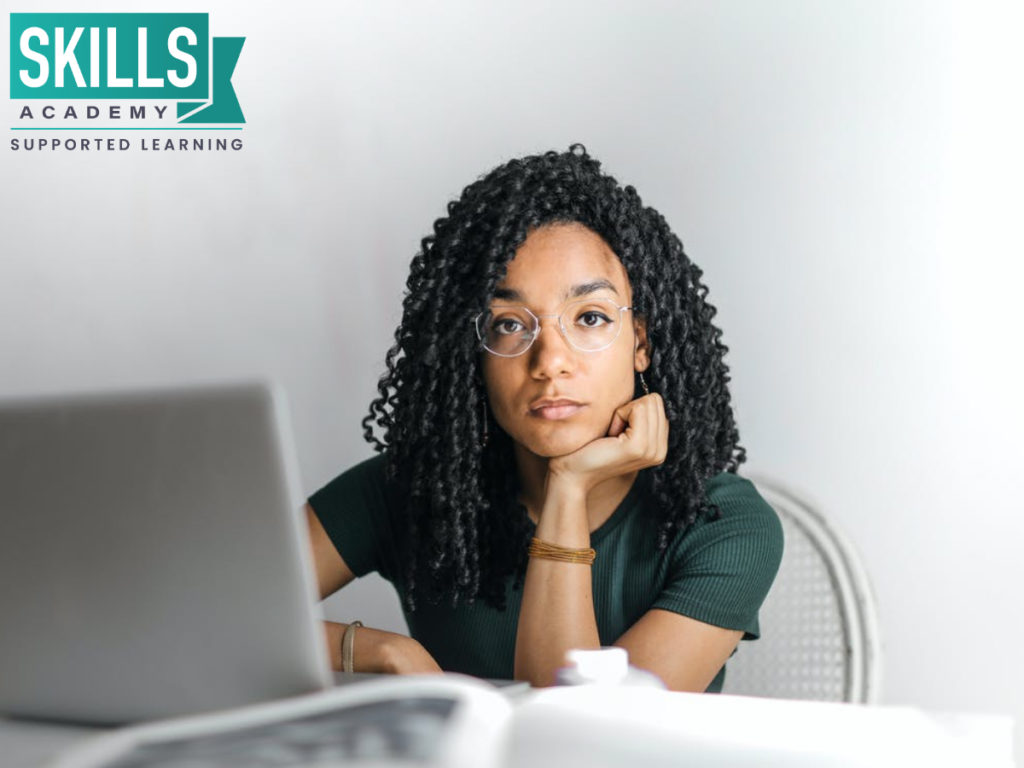 Distance student sitting on her computer doing her homework. Distance Learning vs Part Time Studies - choose the one that fits your lifestyle