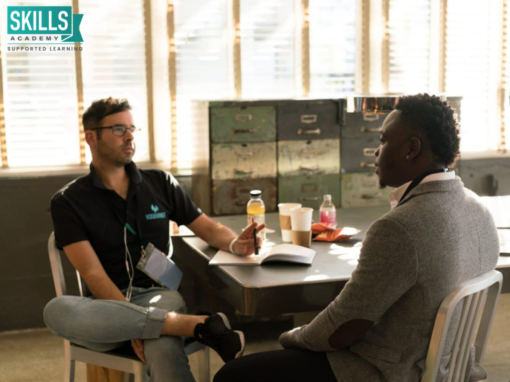 Recruiter interviewing a man while sitting at a table. Follow our Tips for a Successful Interviews and land that dream job!