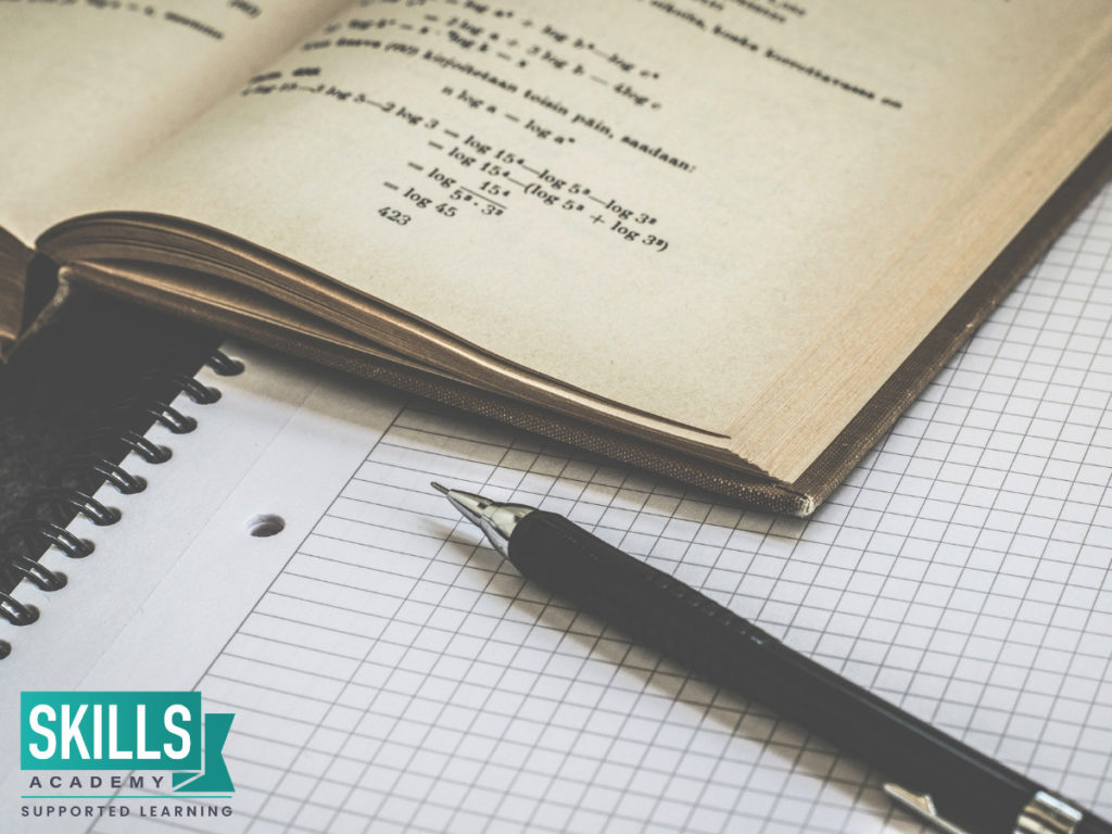 A math book, paper and pen. Having the right materials can help you learn What to Avoid When Writing an Exam
