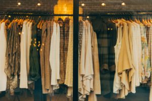 A rack of clothing in a store. Start your own Online Business by selling thrift items online.