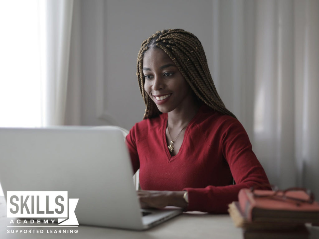 A student smiling happily while reading information on Festive Season and Revision.