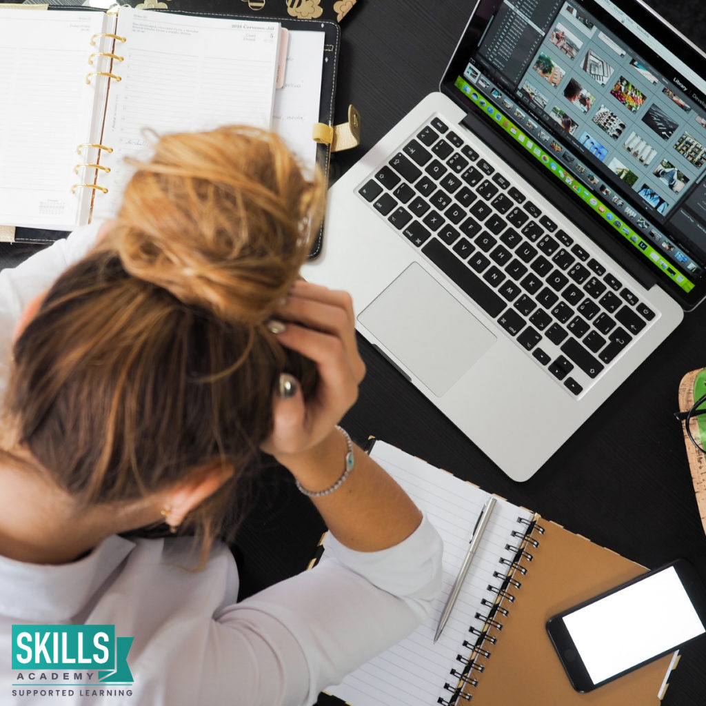 Women sitting with her head resting on her hands, while sitting in front of a computer and planning her future. Learn how to Prepare if we are Faced With Another Lockdown.