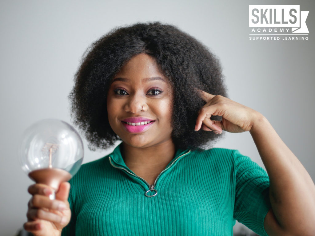 Woman wearing a green sweater pointing to her head while holding a lightbulb. If you know yourself and your qualities, you could get the job you've always wanted. Learn How to Pass a Personality Test right here.