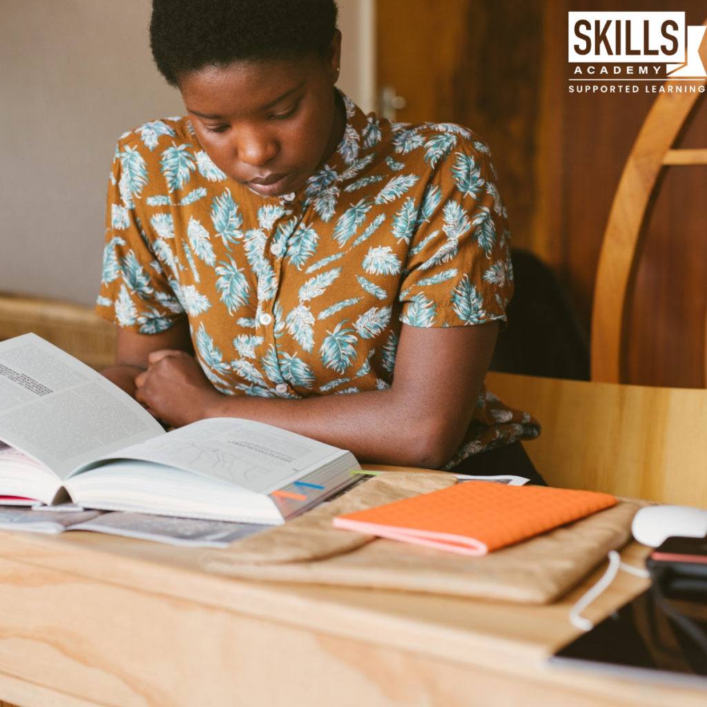 Student sitting at a desk, reading through her notes for her Second Chance Exam. Want to know Who Qualifies for a Supplementary Exam. Find out right here.