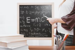A math equation written on a chalkboard. Find Mathematics Matric Past Papers right here.