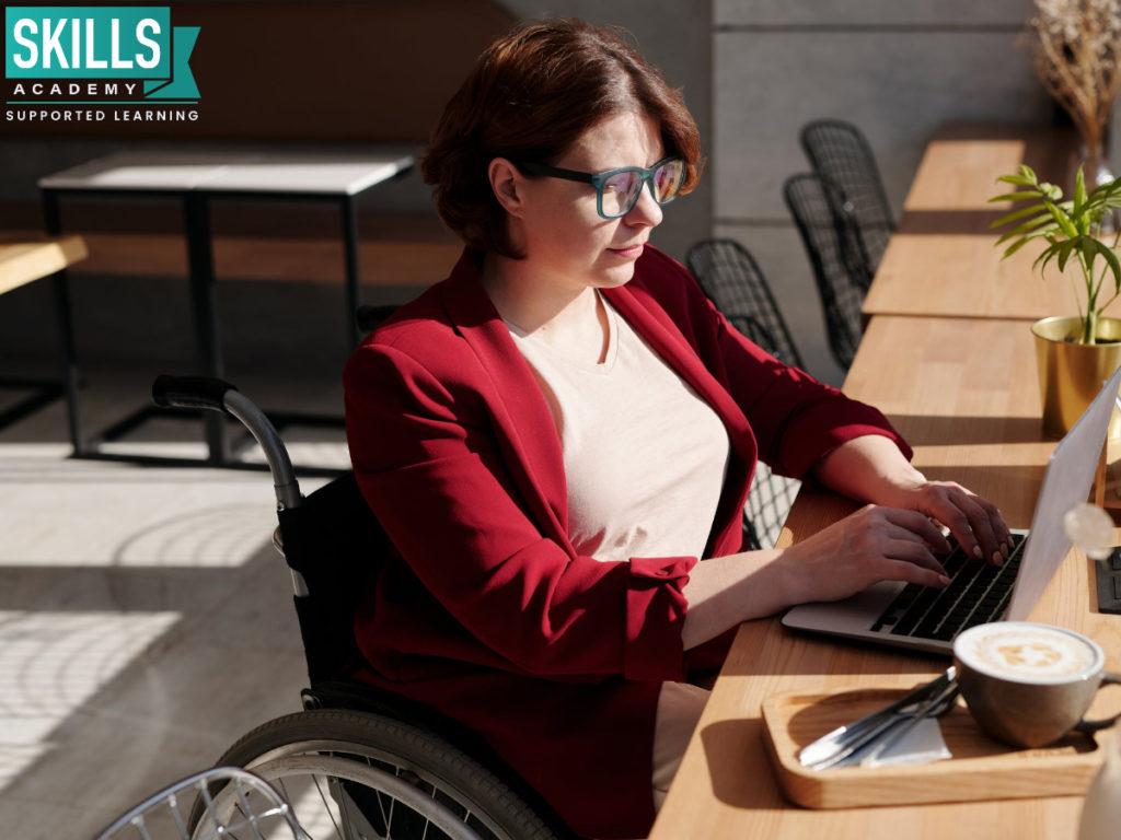 Woman in wheelchair sitting at her desk. Here are the Best Paying Jobs for Women