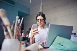 A student with their phone in their hands searching for ways to set career goals. Find out How to Set Career Goals here.