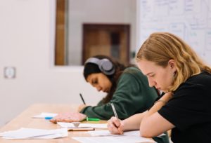 Two students writing notes. Find out how to get Your Matric Results 2020 right here.
