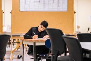 A student writing exams. Get all the information you need about the Higher Education Year to end 2021.