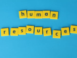 Human Resources spelled out on yellow blocks. Learn how the benefits of an HR Management Course will hep you start a successful career.