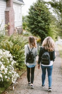 Two students walking down a street. Find out how to support your child if they failed matric right here.