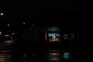 A sign saying money loans. Avoid debt with our tips on how to pay for college without taking loans.