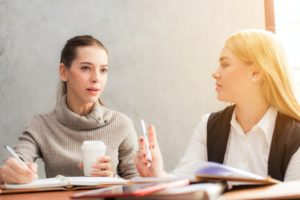 Two women discussing the Career Questions you Should Have the Answers to