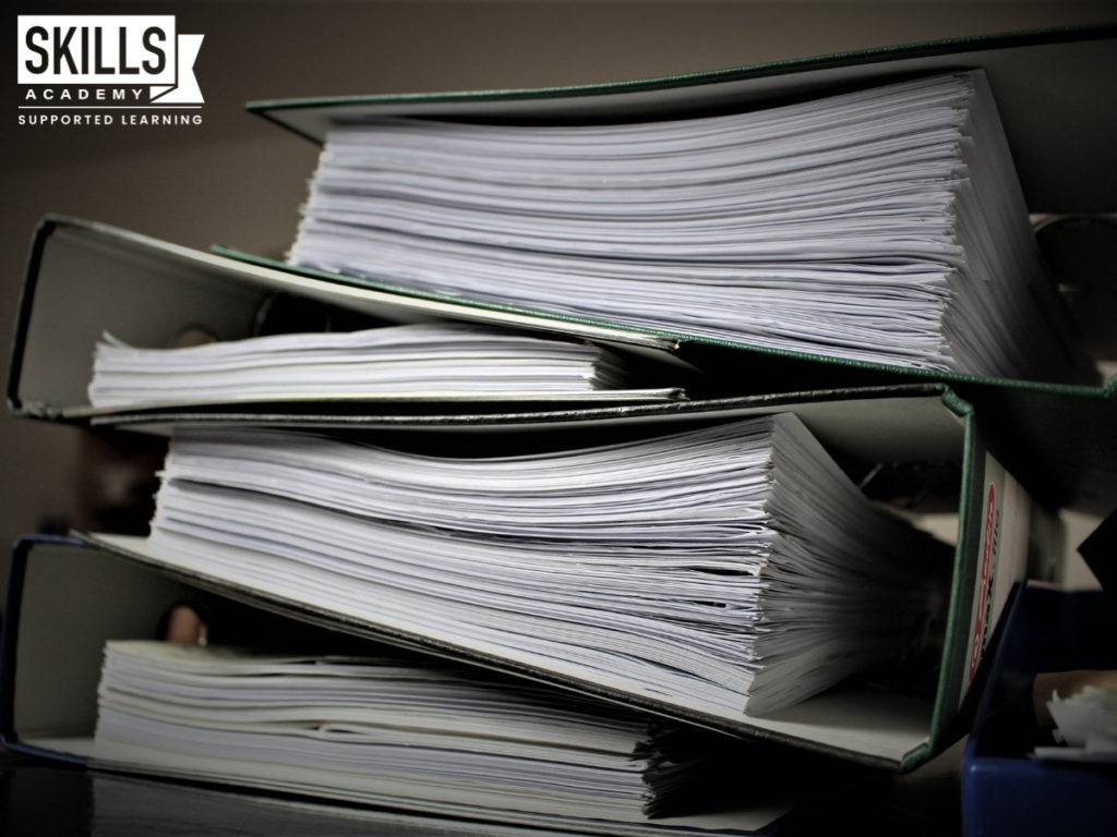 A stack of binders. Learn how to become a success with organisational skills.