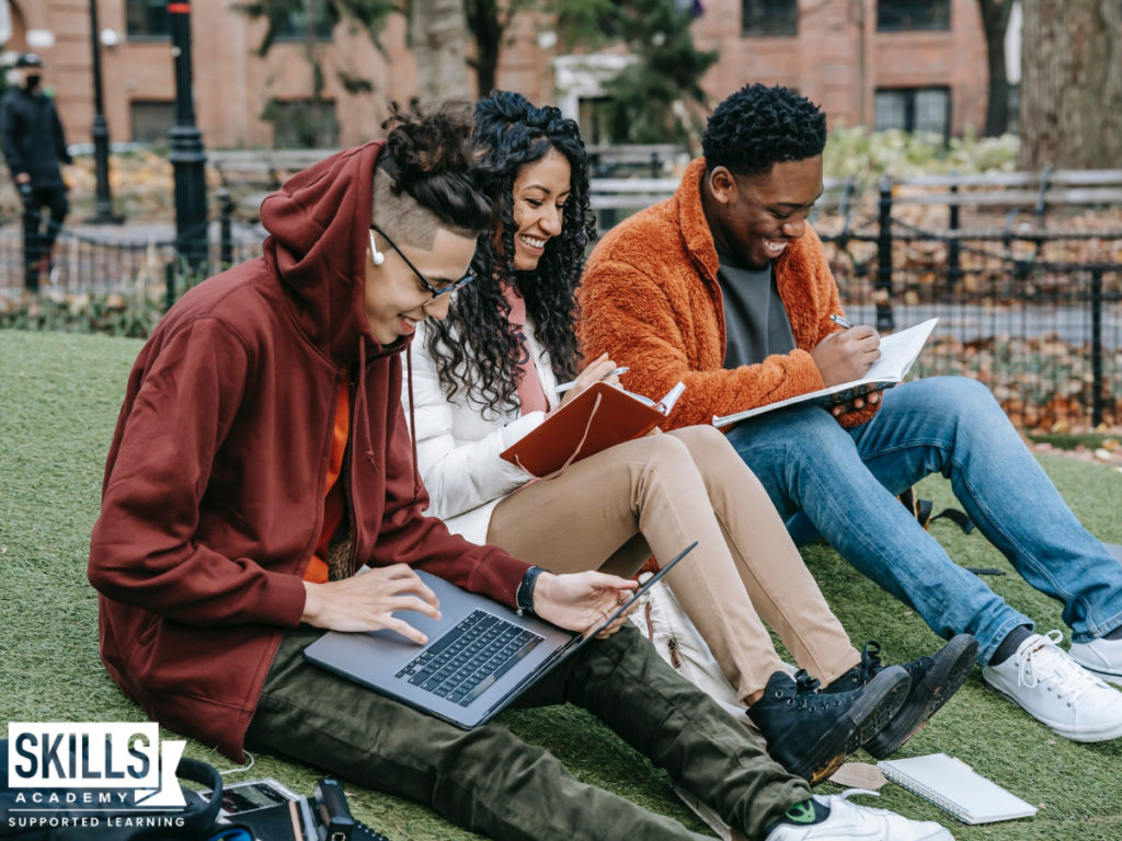 Three students sitting outside studying. Learn all about the benefits of studying a national diploma.