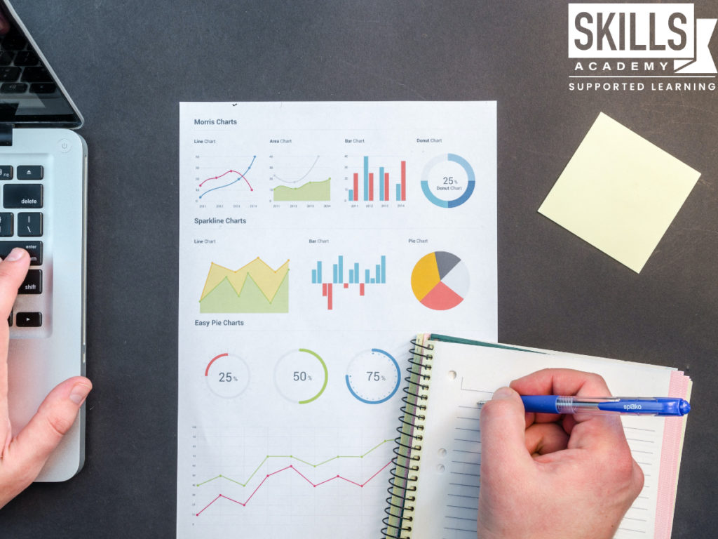 A hand holding a pen over a project chart. Subjects Required to Study Project Management.