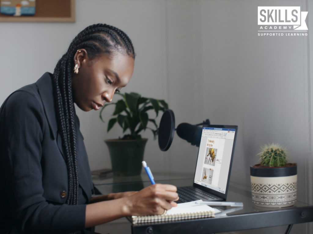 Woman writing matric notes while sitting in front of a laptop. Know the difference between matric rewrite and matric upgrade and improve your matric results.