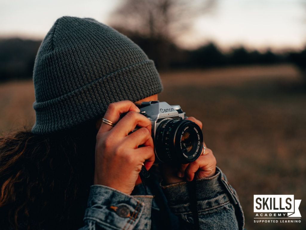 Woman taking a photo, following her passion after studying photography with us. Should you Study Your Passion? Find out more right here.