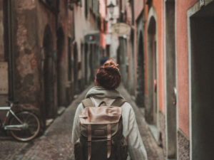 Girl looking at the buildings in front of her while travelling. Here's everything you need to consider when taking a gap year