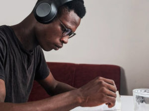 Male student listening to music while studying. Here are careers for introverts