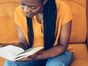 Woman reading and studying for her adult matric exam. The adult matric 2022 exam registration are now open.