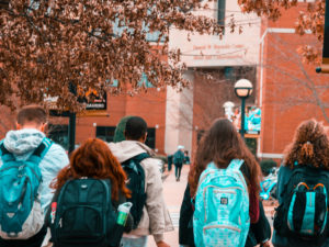 Students walking on campus. Pick the right place when you use our tips on choosing where to study.