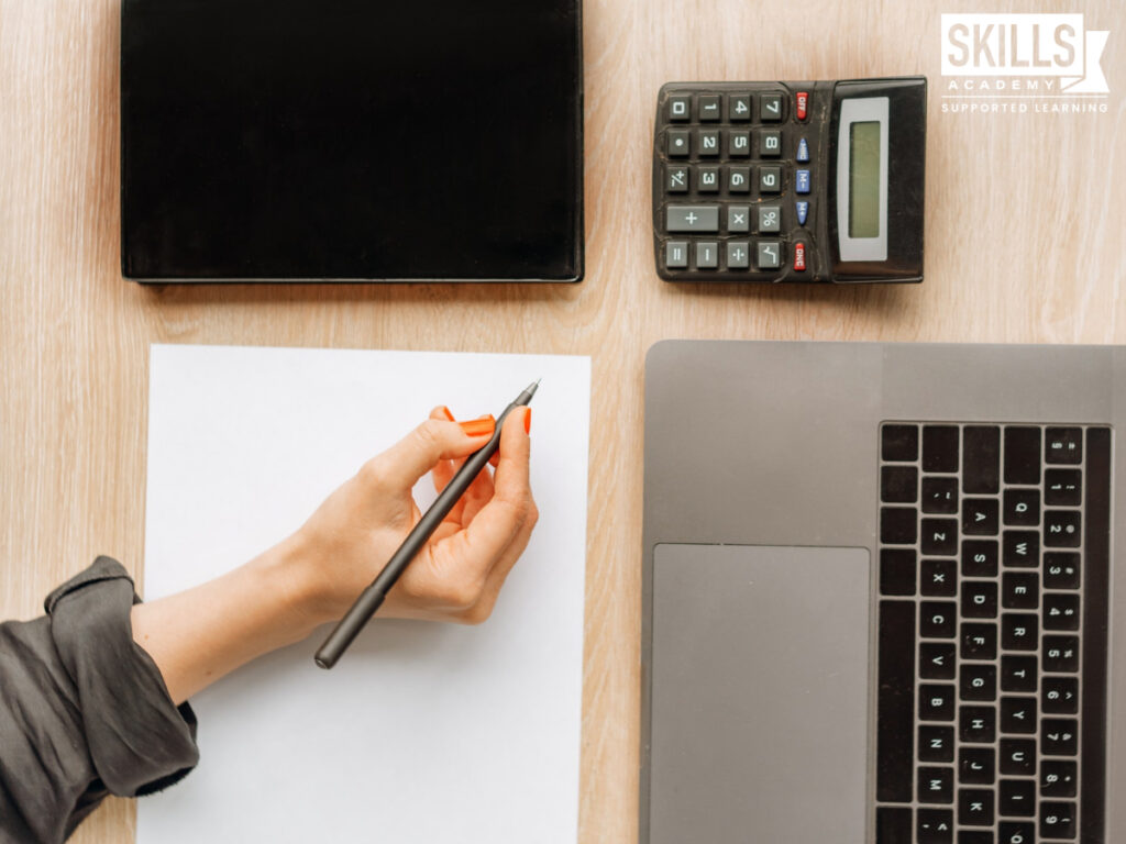 Student calculating his study fees. Find out the differences between a bursary and scholarship here.