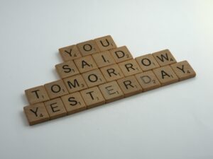 Wooden scrabble letters that say "you said tomorrow yesterday" to show students how to stop procrastinating and focus on studying. Study with us today.