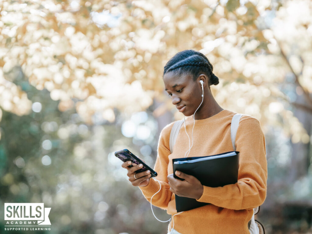 Matriculant using her phone to get her matric results. Take a look at where to get your matric results here.