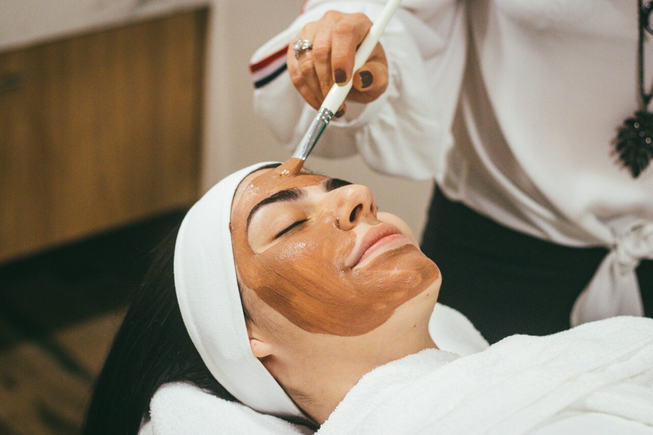 A beauty therapist is giving a client a facial after learning why you should choose a career in beauty therapy. Study our Beauty Courses today!