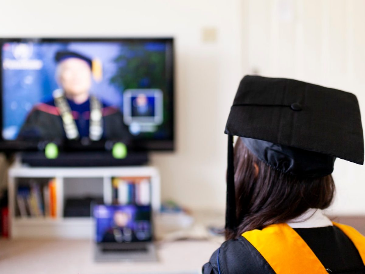 lady watching her graduation on her tv. ICB-paper-based-and-online-exam-whats-the-difference