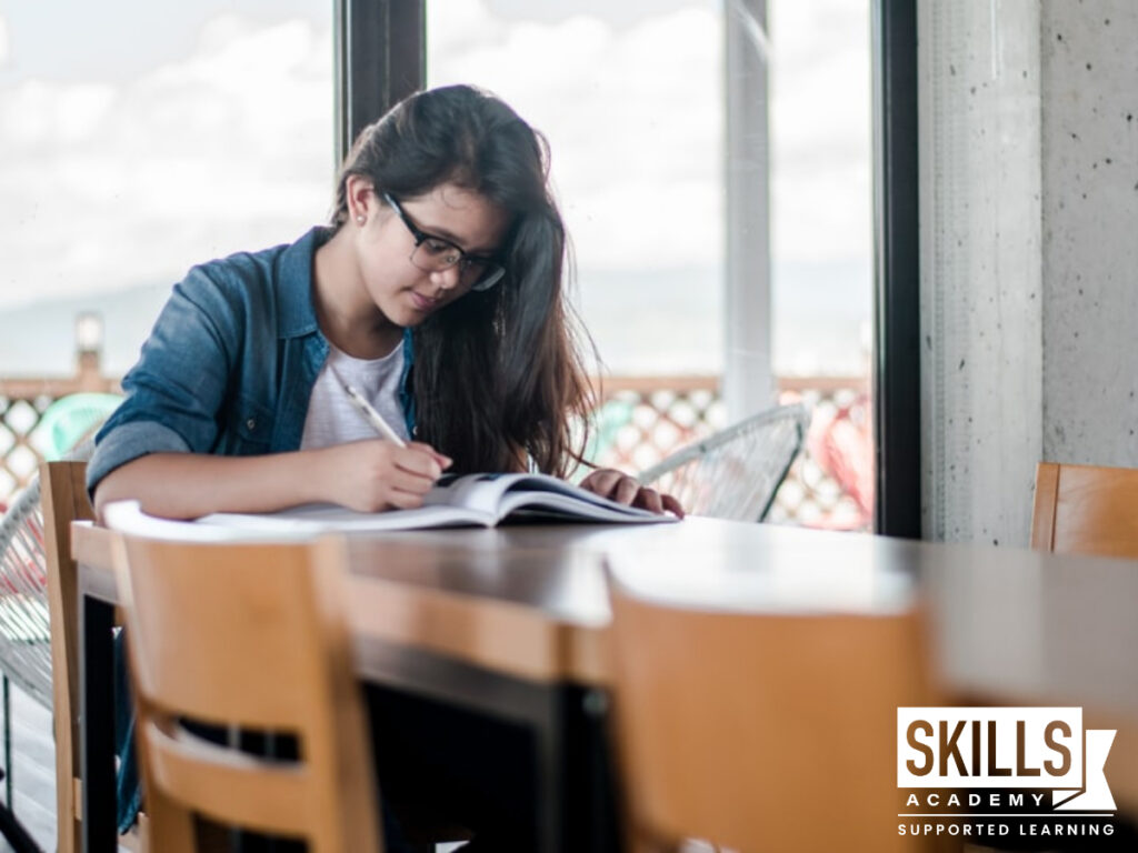 Woman writing in a book. I've applied to skills academy, What happens next?