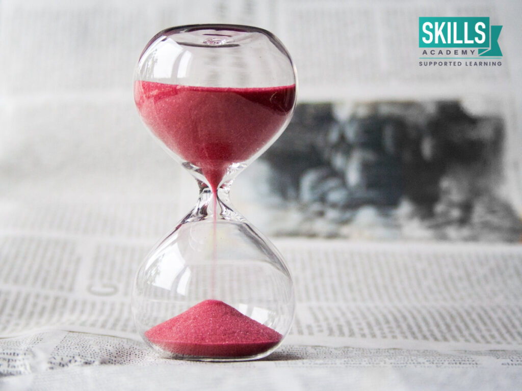 Hourglass in front of news paper. Short Management Courses