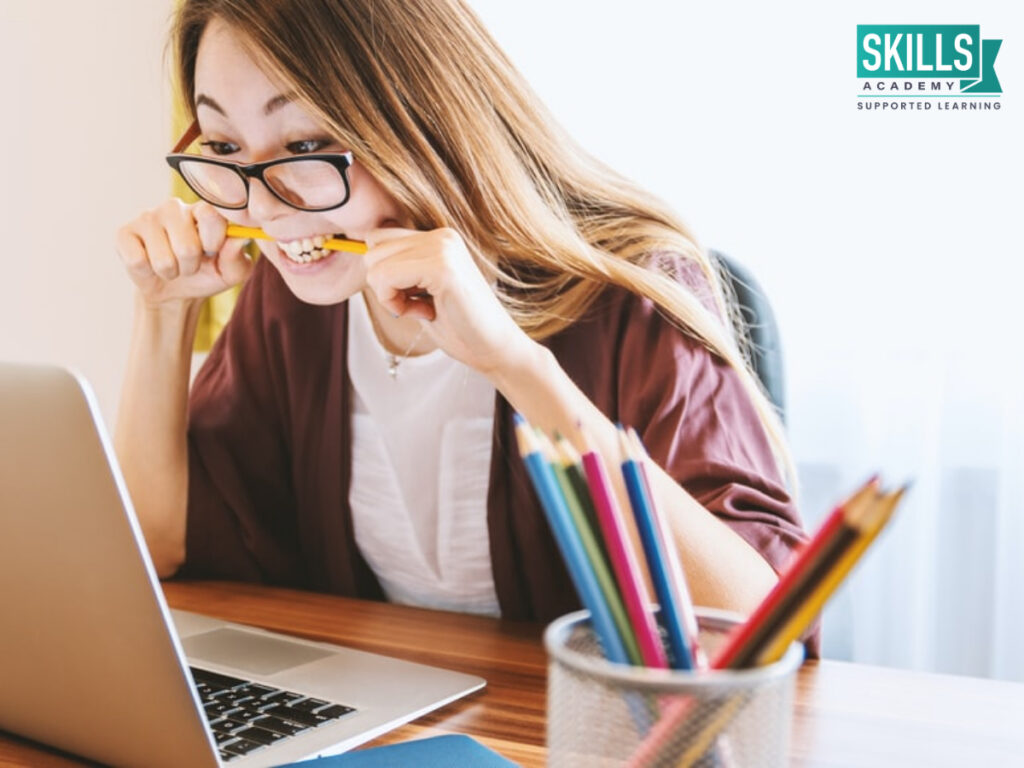 Girl biting a pencil looking at her laptop. Tips to help you successfully transition to tertiary studies.