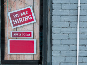 A few signs hanging from a door. How to Create a CV Without Experience