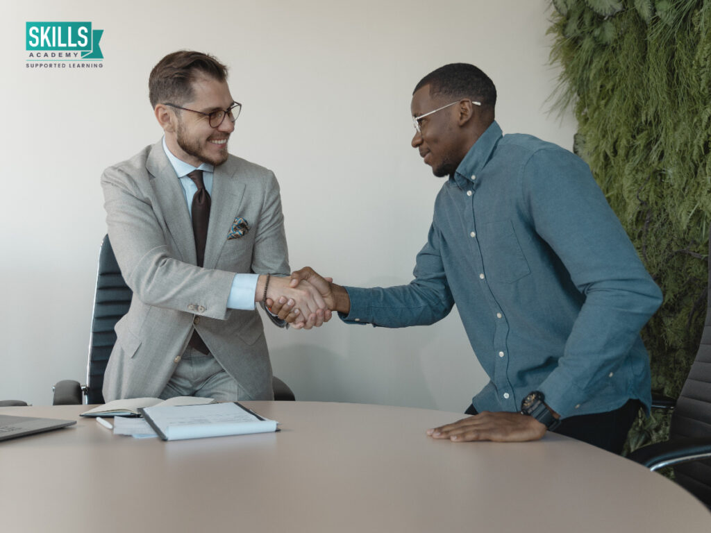 Two guys shaking hands. How to Talk About Your Weaknesses in an Interview