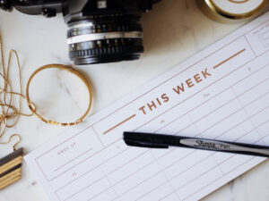 Daily planner with a pen on top of it. Tips on Creating a Daily Work Planner